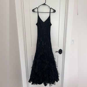 Fits more like a size 8.  Rare feather dress.